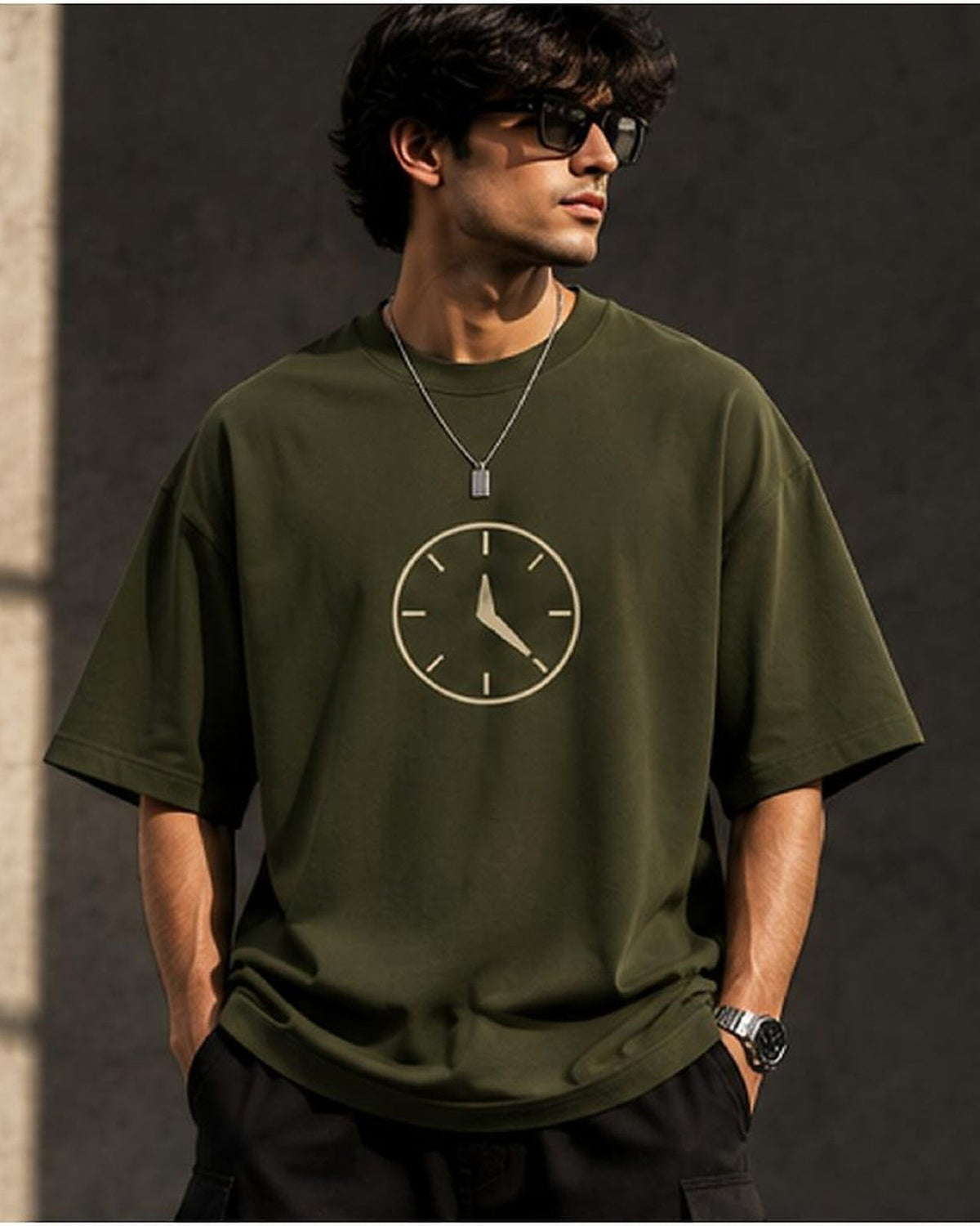 Model wearing the Selinx INSPIRATION olive oversized tee, front view with cream clock graphic
