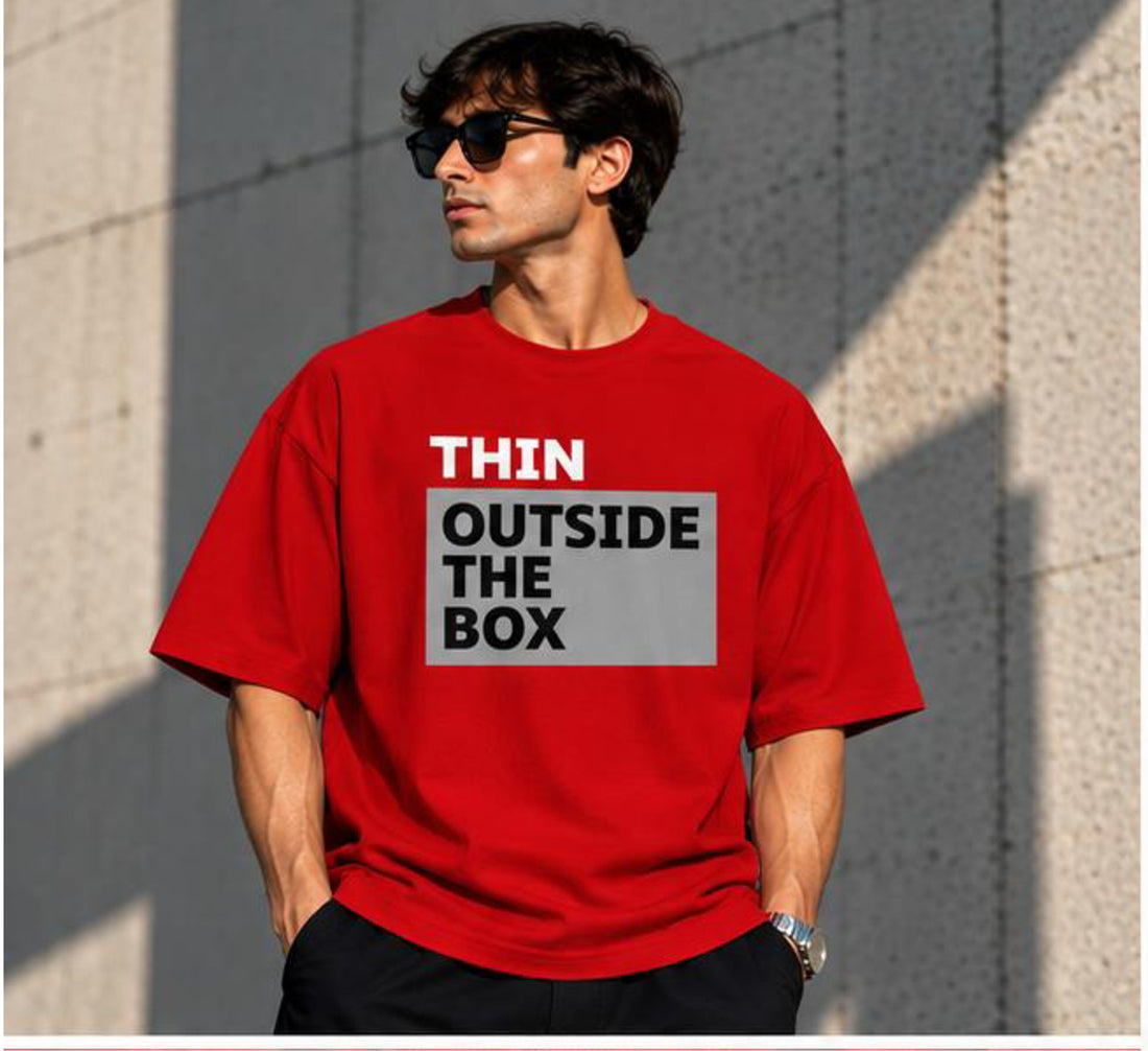 Model wearing the Selinx OUTSIDE THE BOX red oversized tee, front view with block typography print